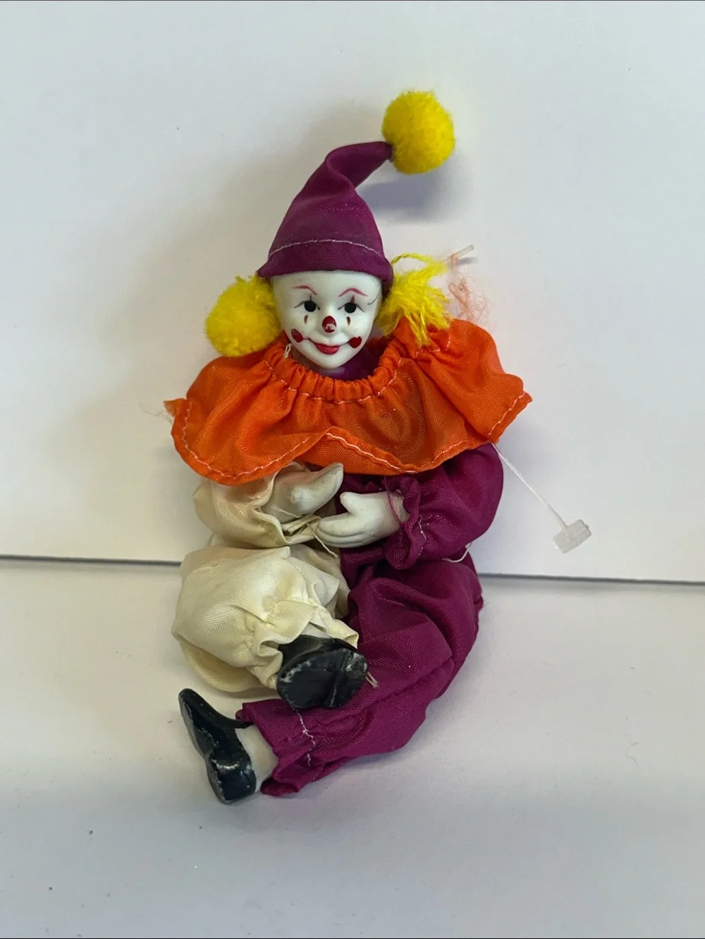 Porcelain Clown Doll with Orange Ruffle and Purple Outfit